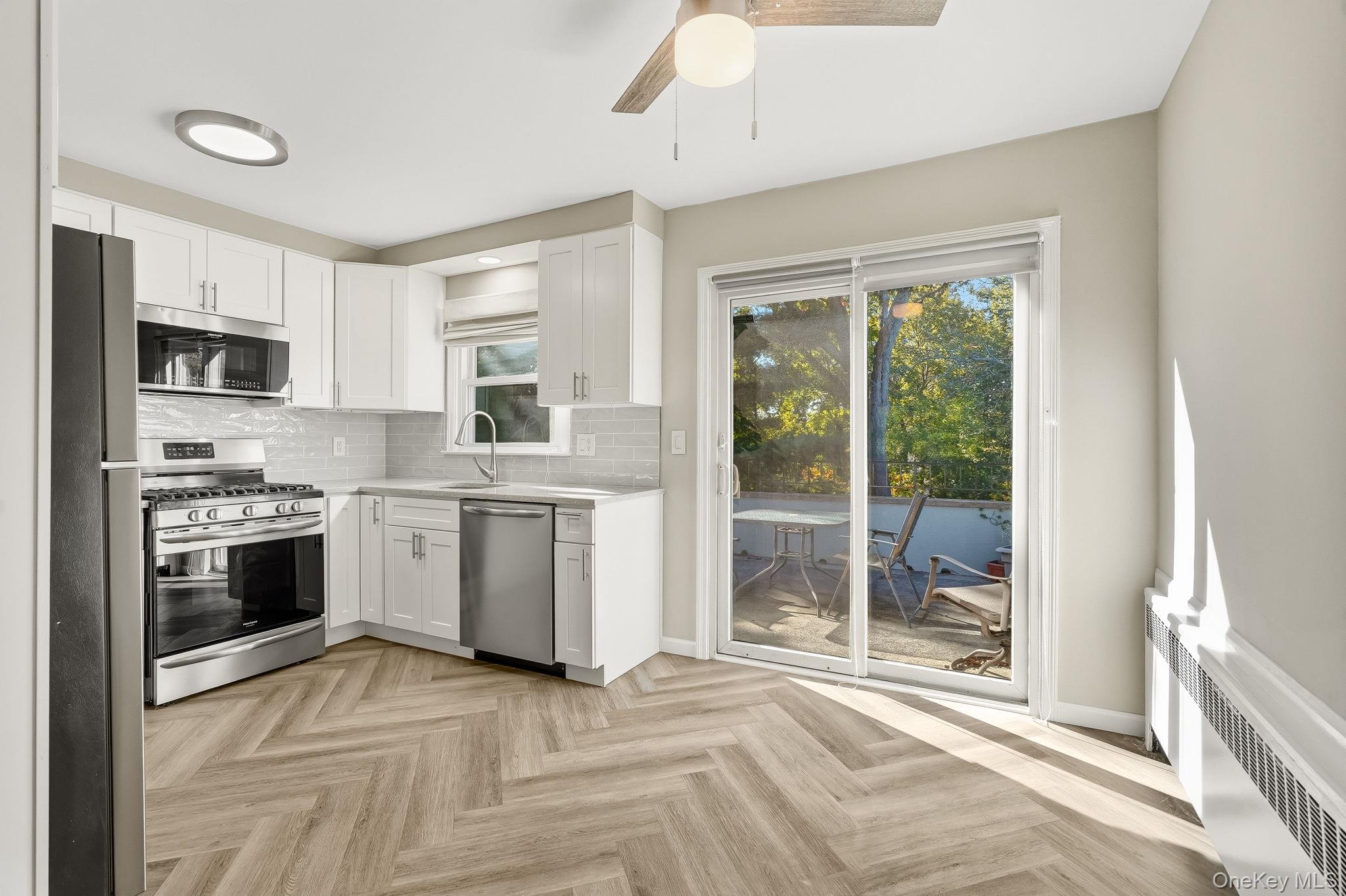 23 Young Place, Unit 2 Tuckahoe, NY 10707 - Photo 5 of 20 a kitchen with a stove a sink and a refrigerator