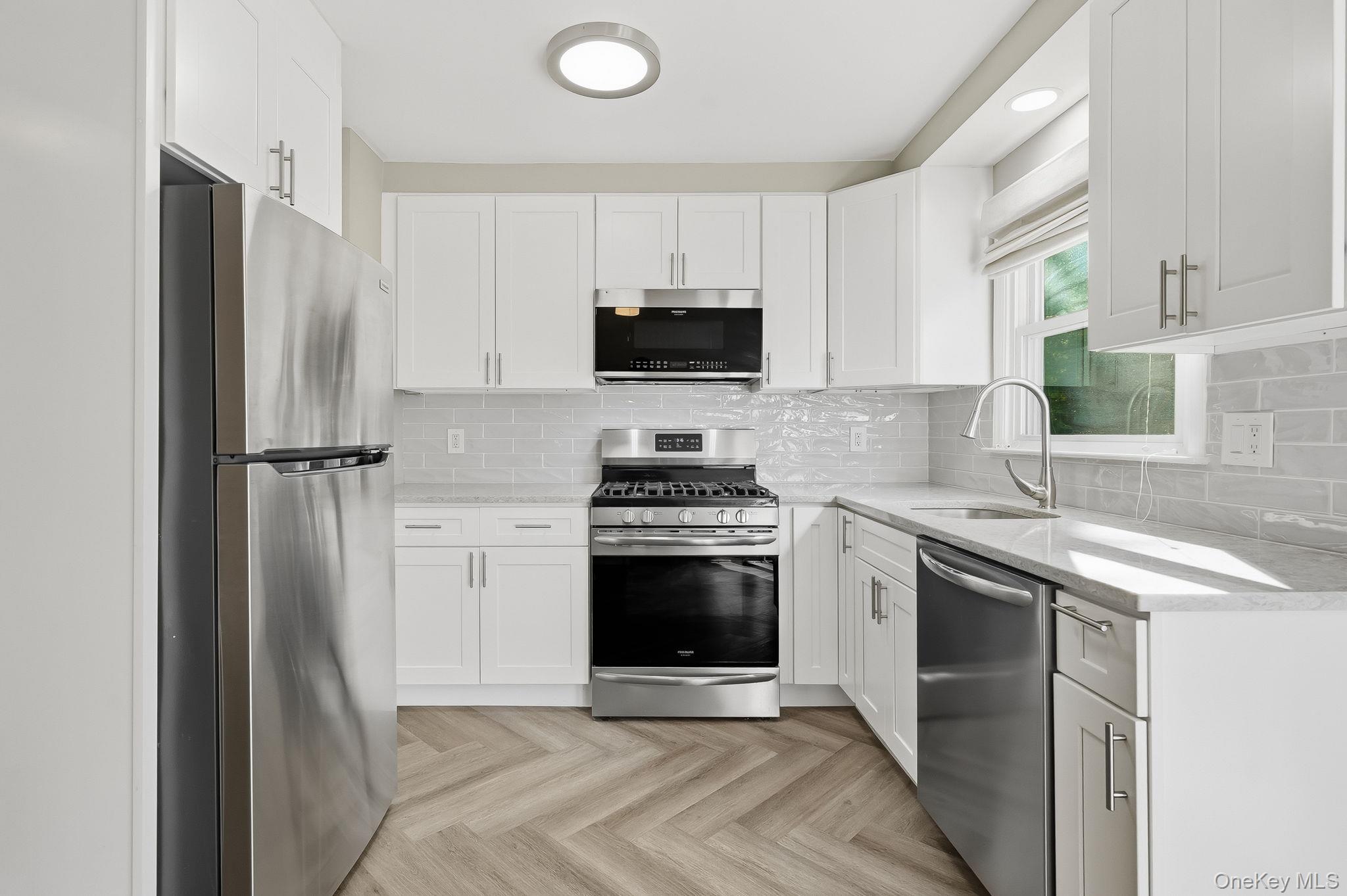 23 Young Place, Unit 2 Tuckahoe, NY 10707 - Photo 7 of 20 a kitchen with stainless steel appliances granite countertop a stove a refrigerator and a sink