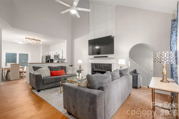 a living room with furniture a fireplace and a flat screen tv