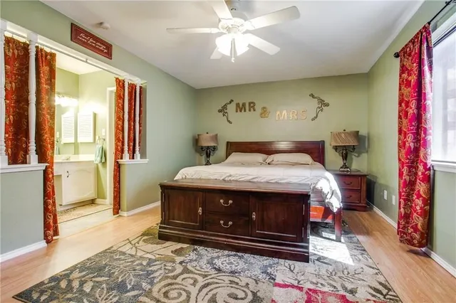 a bed sitting in a bedroom next to a window