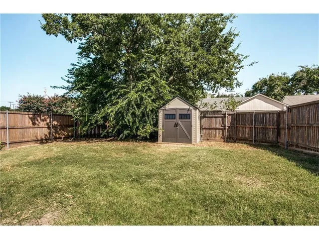 a front view of a house with yard and garage
