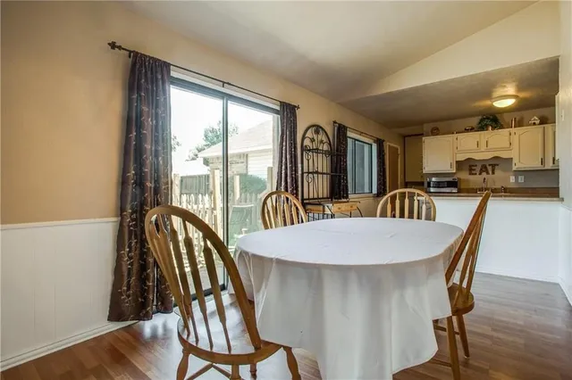 a dining room with furniture and wooden floor