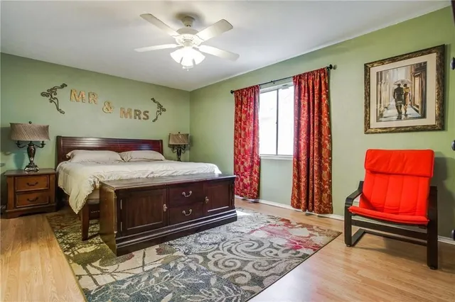 a bedroom with a bed and wooden floor