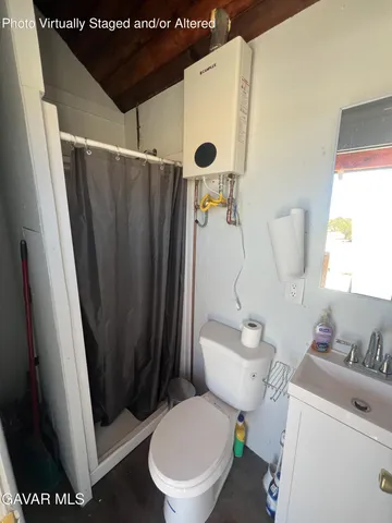a bathroom with a sink and mirror with toilet