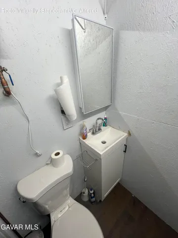 a view of a room with wooden floor