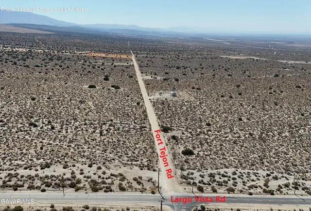 a view of a town with mountains in the background