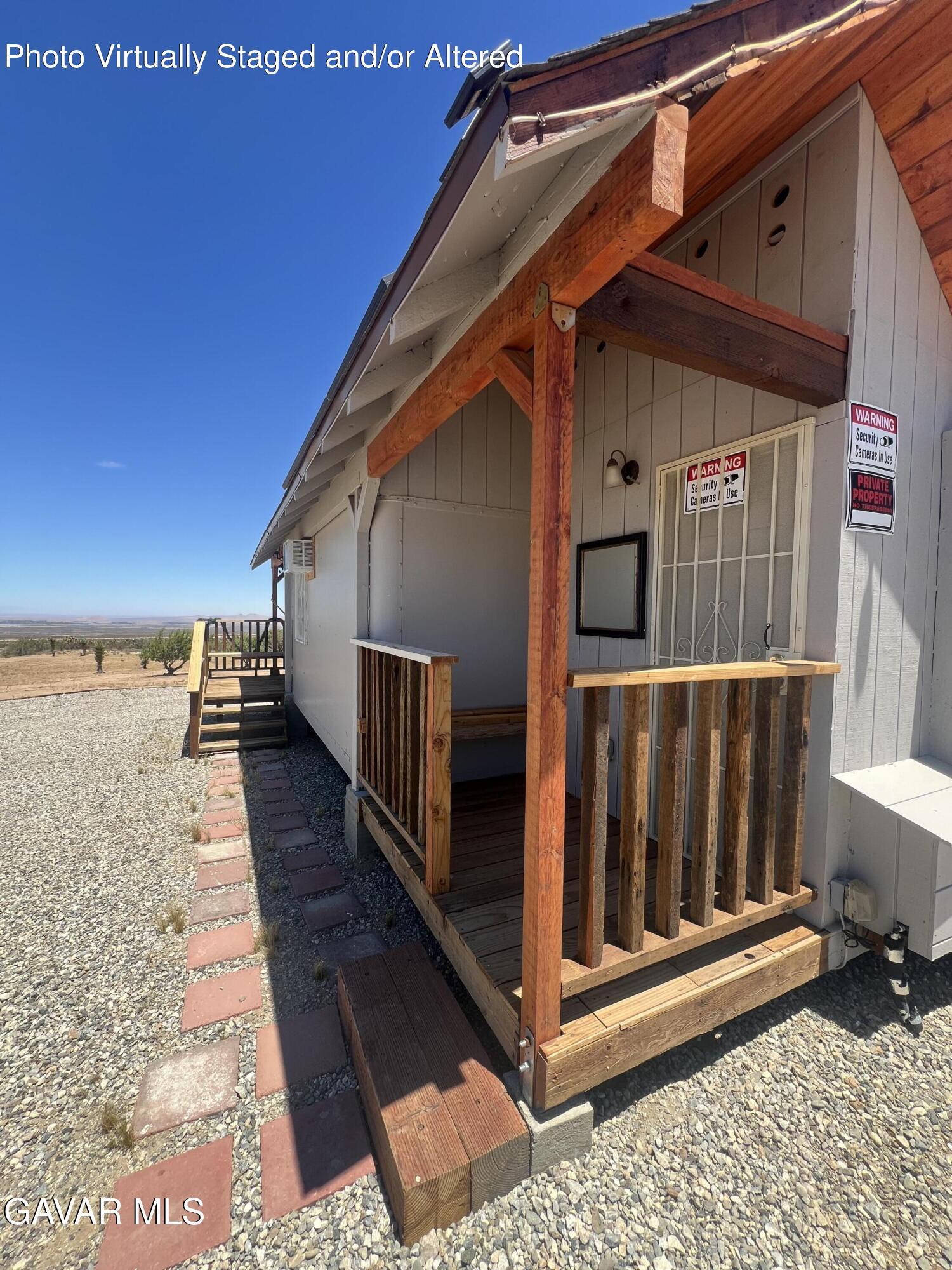 200 Ave Y/fort Tejon Road Llano, CA 93544 - Photo 5 of 30 a view of a balcony with wooden floor and fence