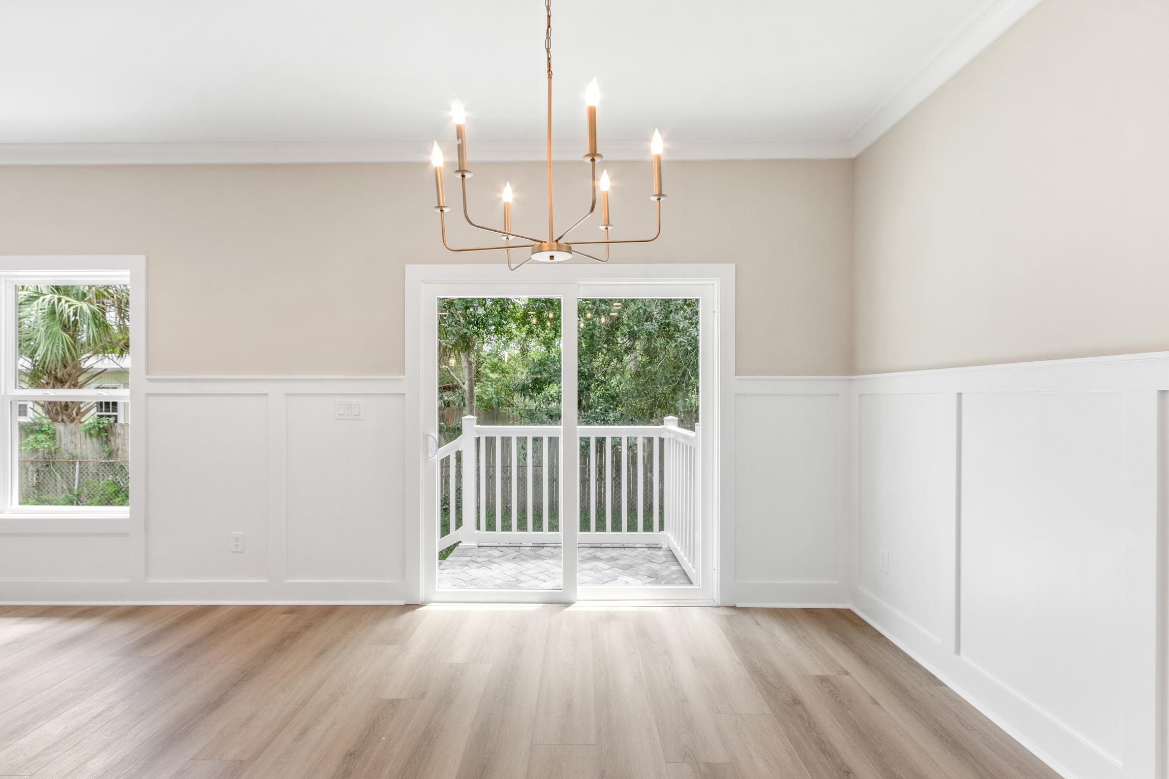 6334 Salado Road St. Augustine, FL 32080 - Photo 14 of 37 an empty room with wooden floor fan and windows