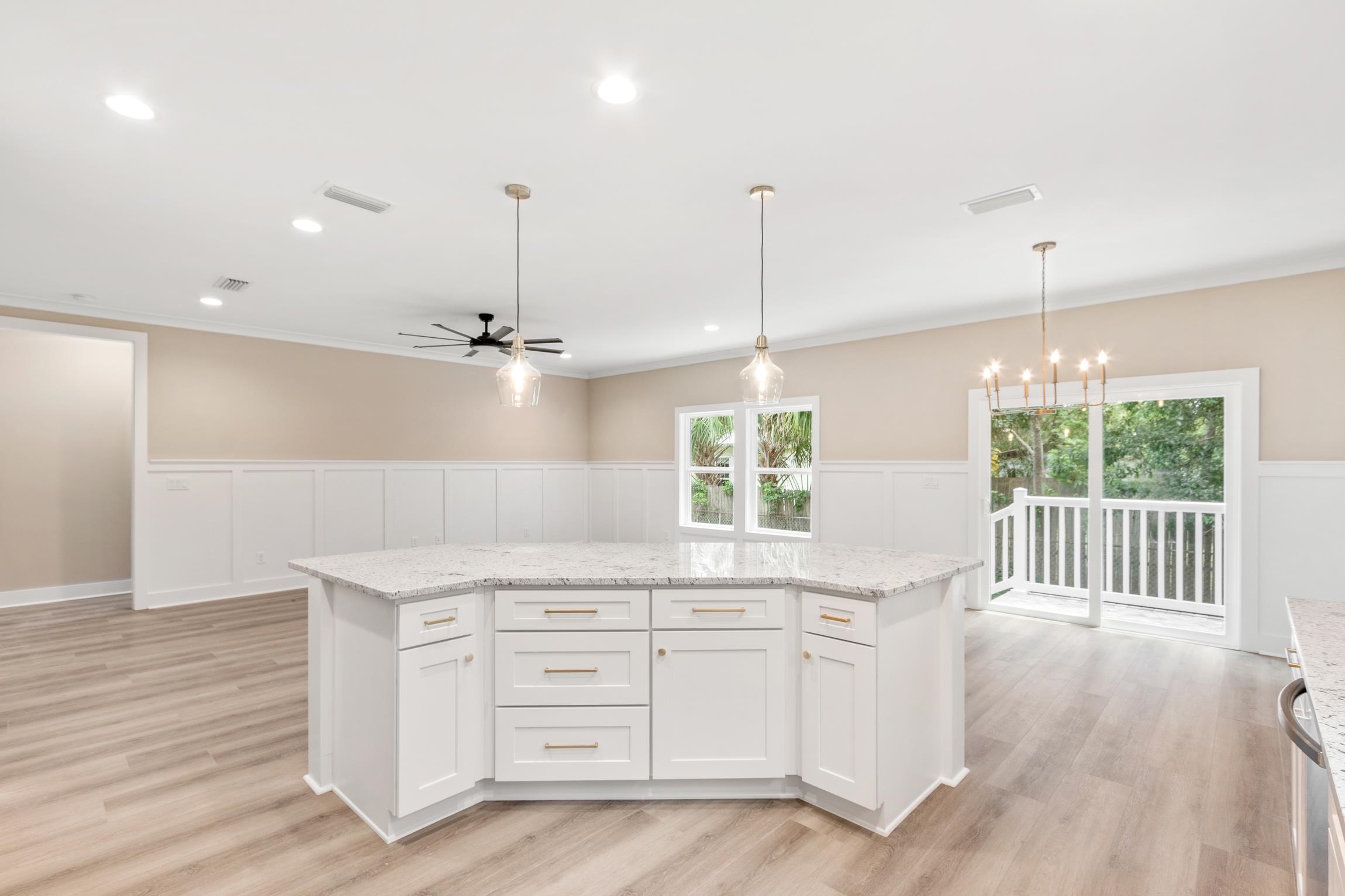 6334 Salado Road St. Augustine, FL 32080 - Photo 15 of 37 a open kitchen with granite countertop a stove a sink and white cabinets with wooden floor