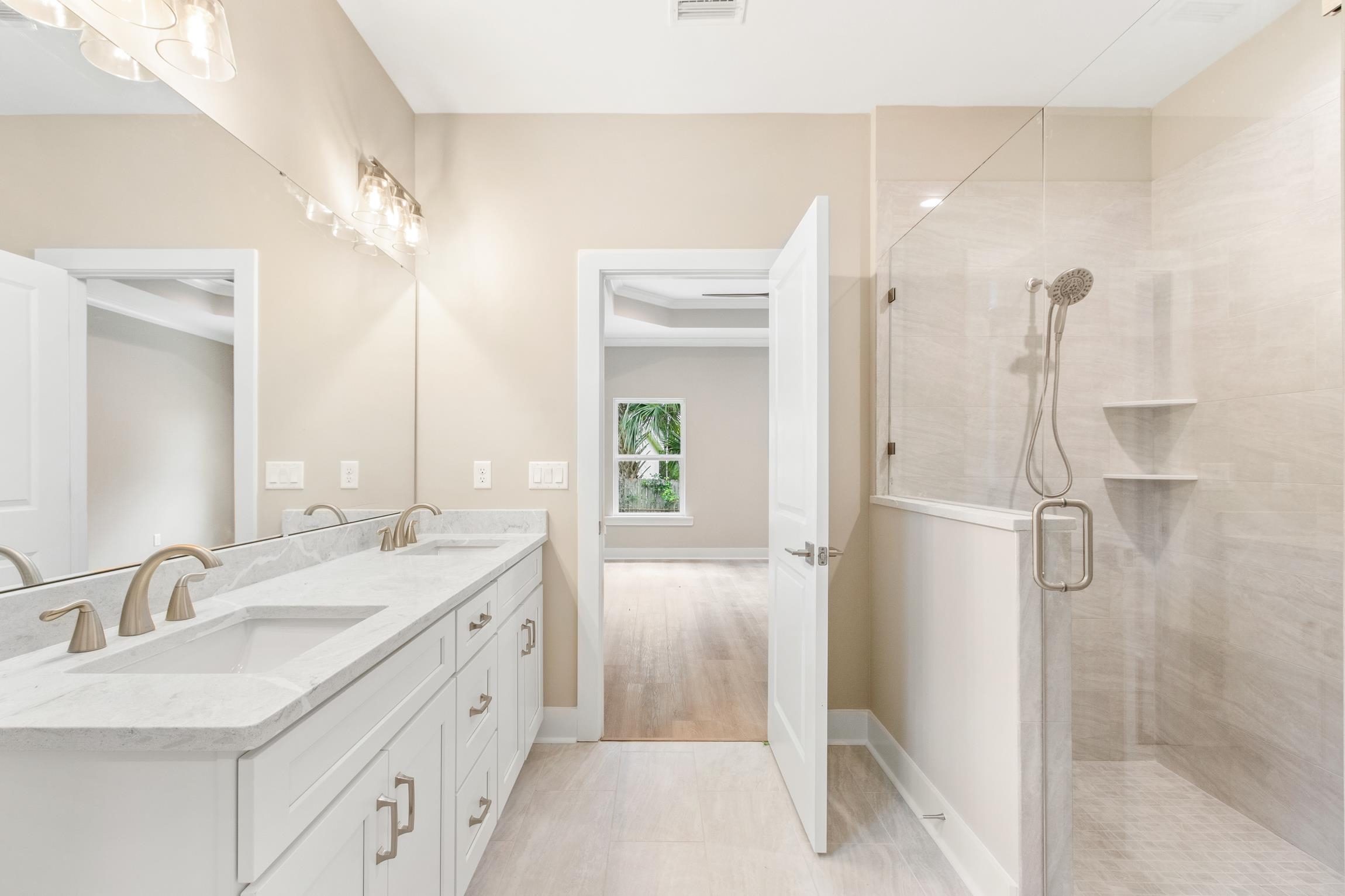 6334 Salado Road St. Augustine, FL 32080 - Photo 19 of 37 a spacious bathroom with a double vanity sink a mirror and shower