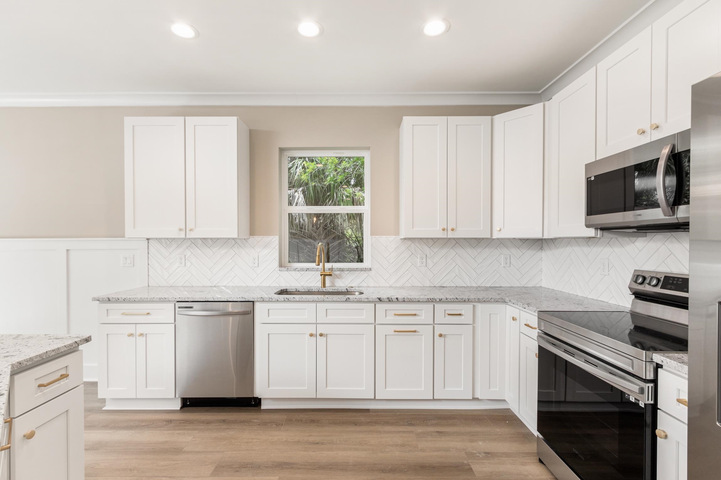 6334 Salado Road St. Augustine, FL 32080 - Photo 9 of 37 a kitchen with stainless steel appliances granite countertop a stove a sink and a microwave
