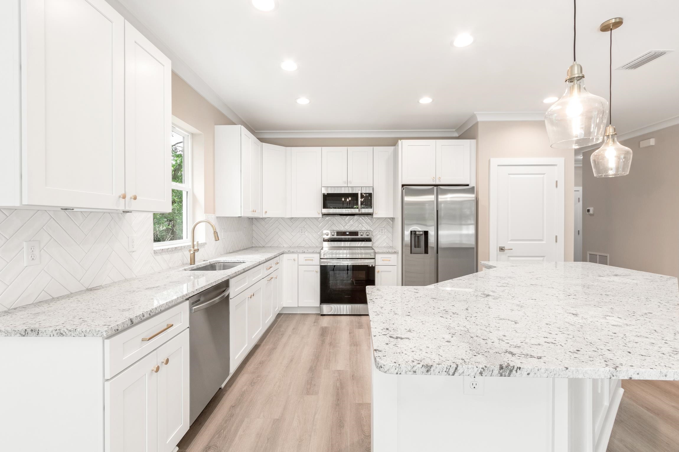 6334 Salado Road St. Augustine, FL 32080 - Photo 10 of 37 a large kitchen with granite countertop a large center island a sink stainless steel appliances and cabinets