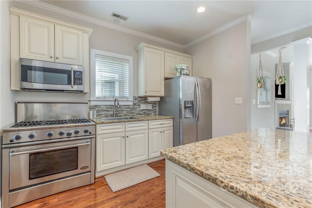 300 Mill Road Charlotte, NC 28216 - Photo 10 of 31 a kitchen with stainless steel appliances granite countertop a stove microwave and refrigerator