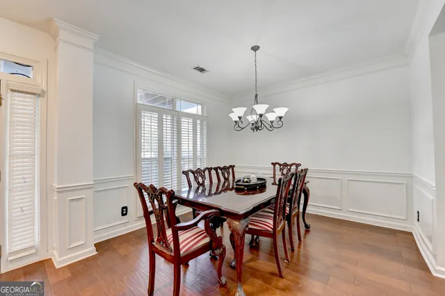a view of a dining room with furniture window and wooden floor