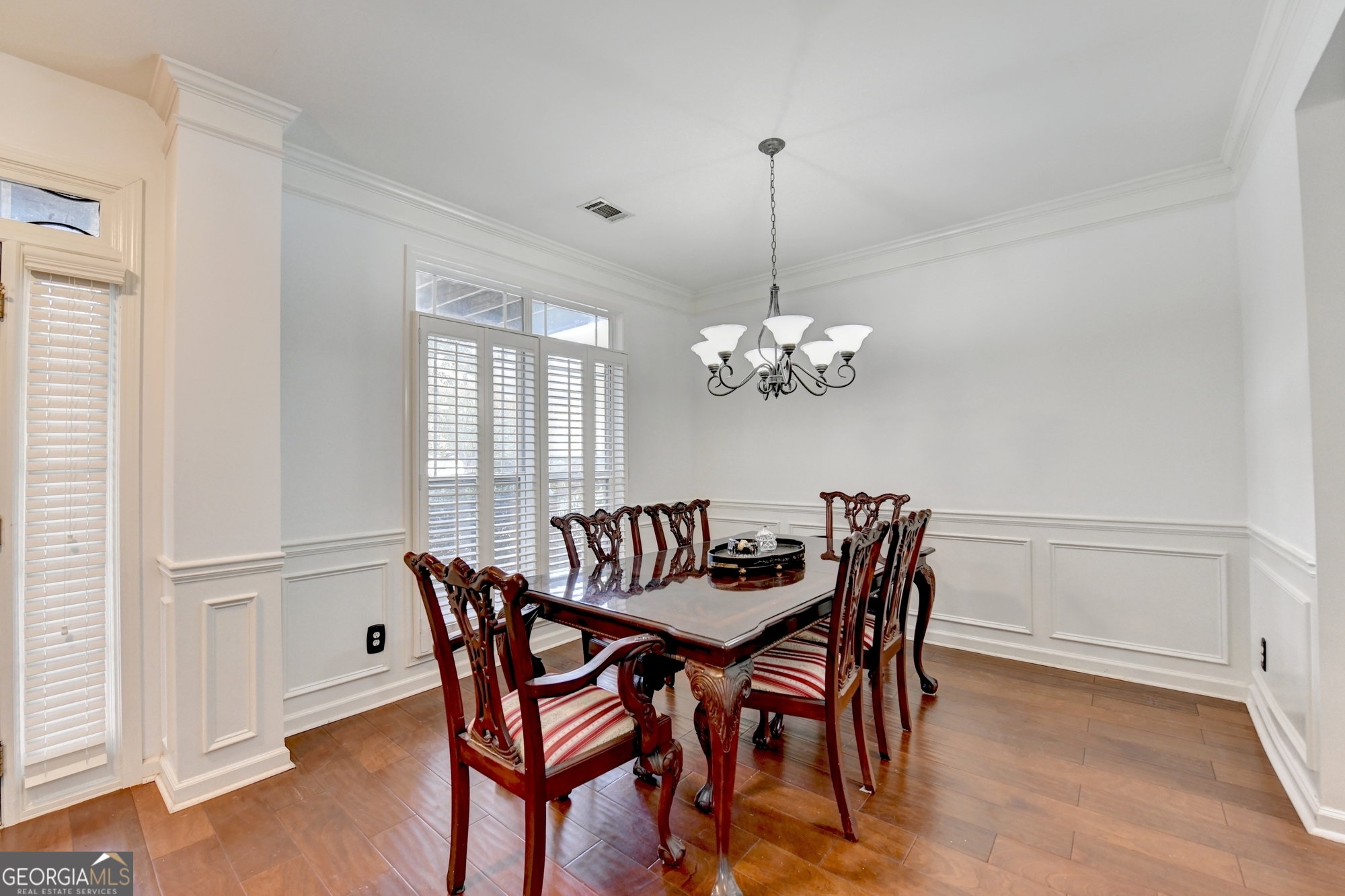 952 Cambron Cmns Trace Suwanee, GA 30024 - Photo 11 of 69 a view of a dining room with furniture a chandelier and wooden floor