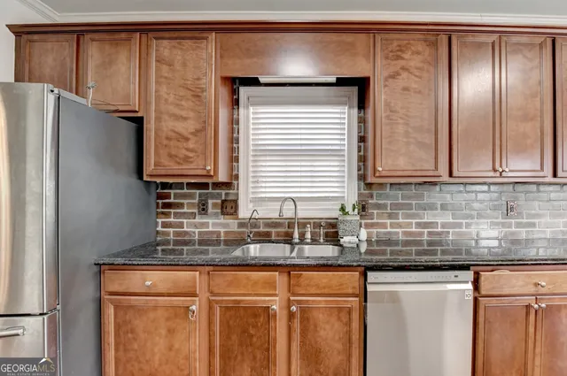 a kitchen with granite countertop cabinets stainless steel appliances and wooden floor