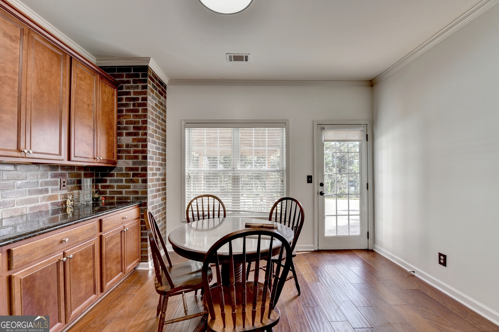 952 Cambron Cmns Trace Suwanee, GA 30024 - Photo 16 of 69 a view of a dining room with furniture window and wooden floor