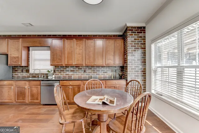 a dining room with furniture and wooden floor
