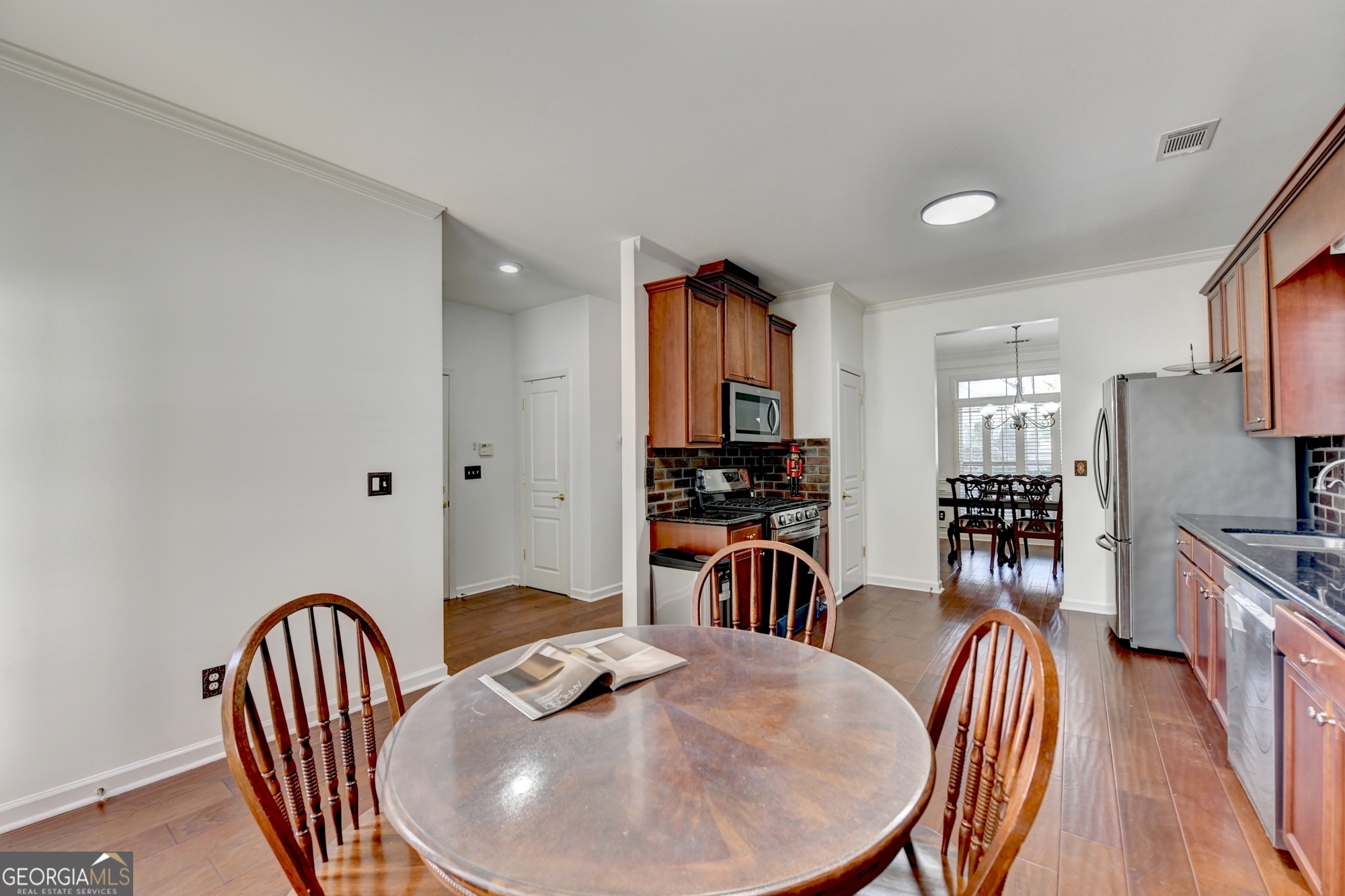 952 Cambron Cmns Trace Suwanee, GA 30024 - Photo 18 of 69 a view of a a dining room with furniture window and wooden floor