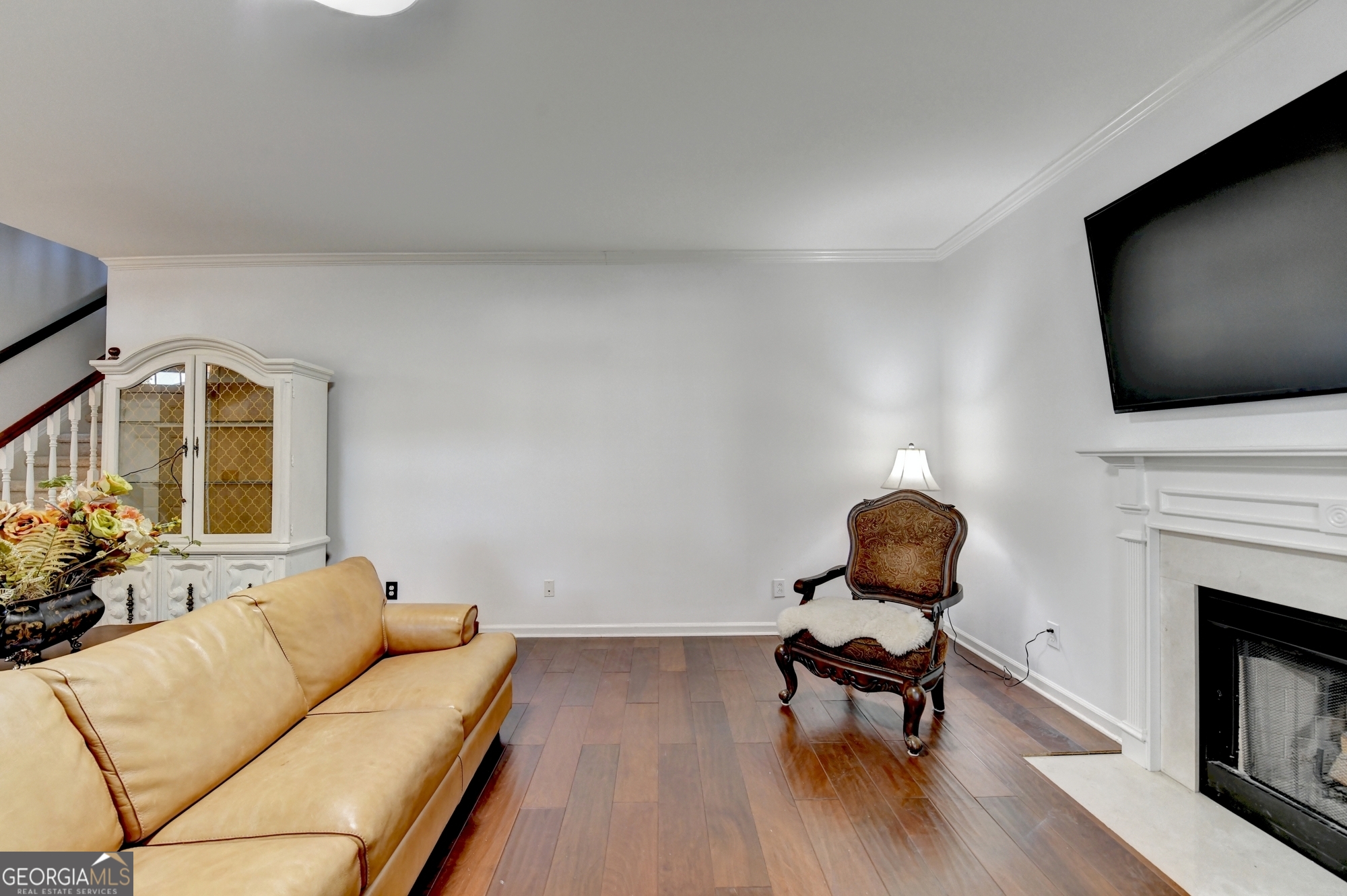 952 Cambron Cmns Trace Suwanee, GA 30024 - Photo 24 of 69 a living room with furniture a fireplace and a flat screen tv