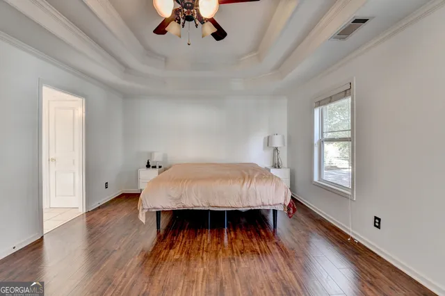a view of a workspace with furniture and wooden floor