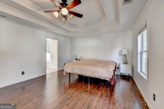a view of a workspace with furniture and wooden floor