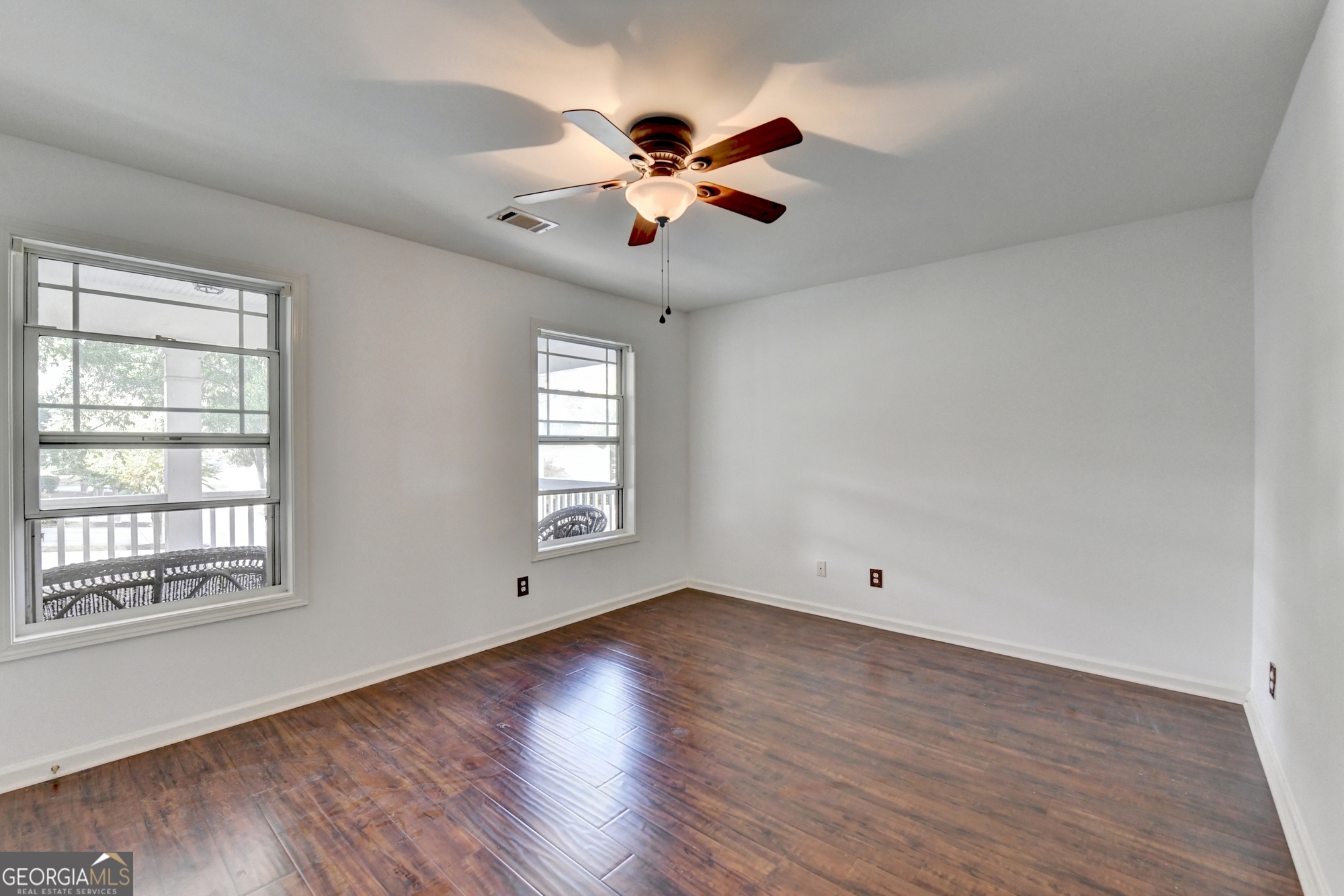 952 Cambron Cmns Trace Suwanee, GA 30024 - Photo 40 of 69 a view of an empty room with wooden floor and a window