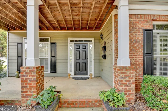 a view of a dining room with furniture wooden floor and a chandelier