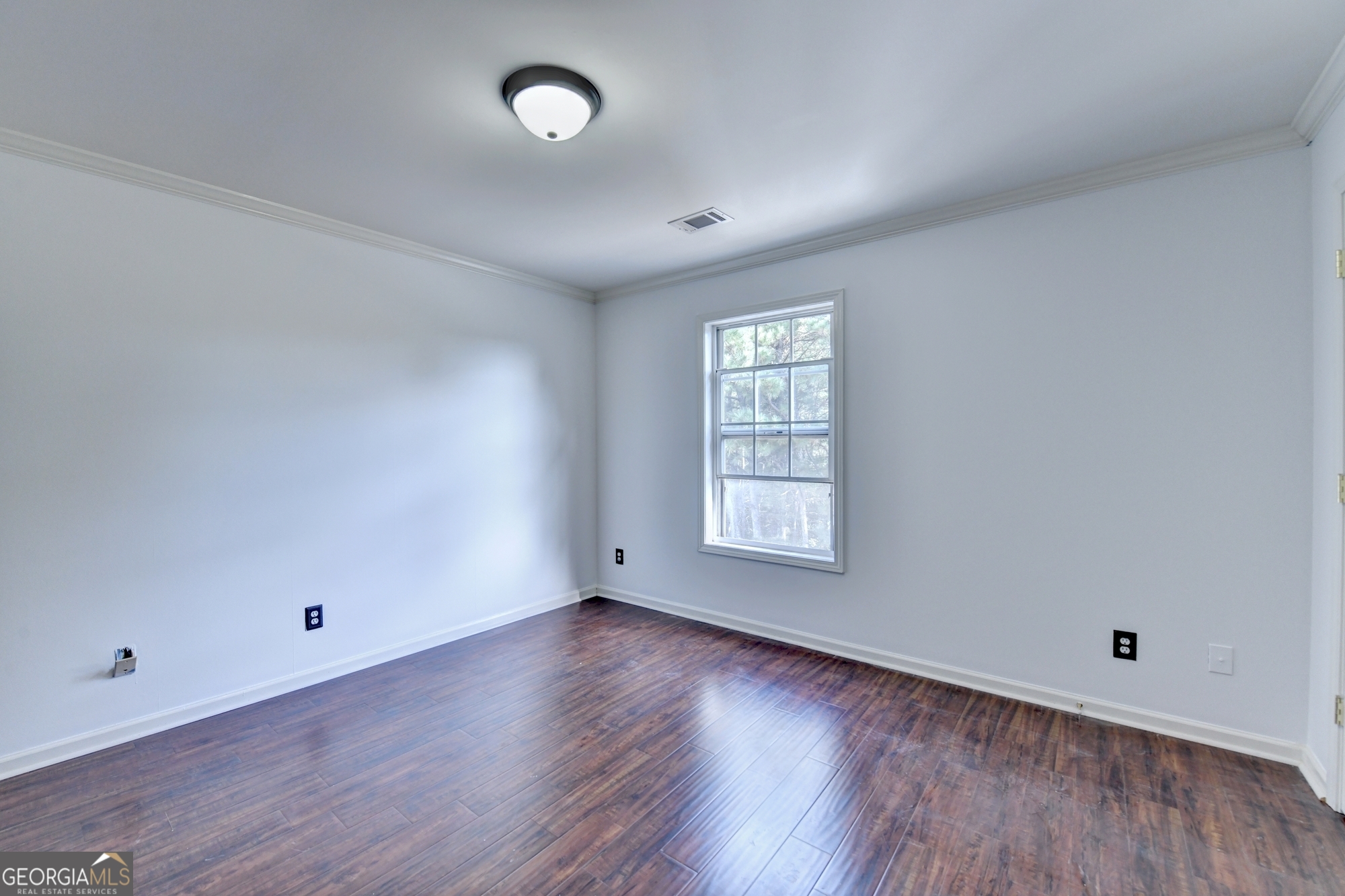 952 Cambron Cmns Trace Suwanee, GA 30024 - Photo 45 of 69 an empty room with wooden floor and windows