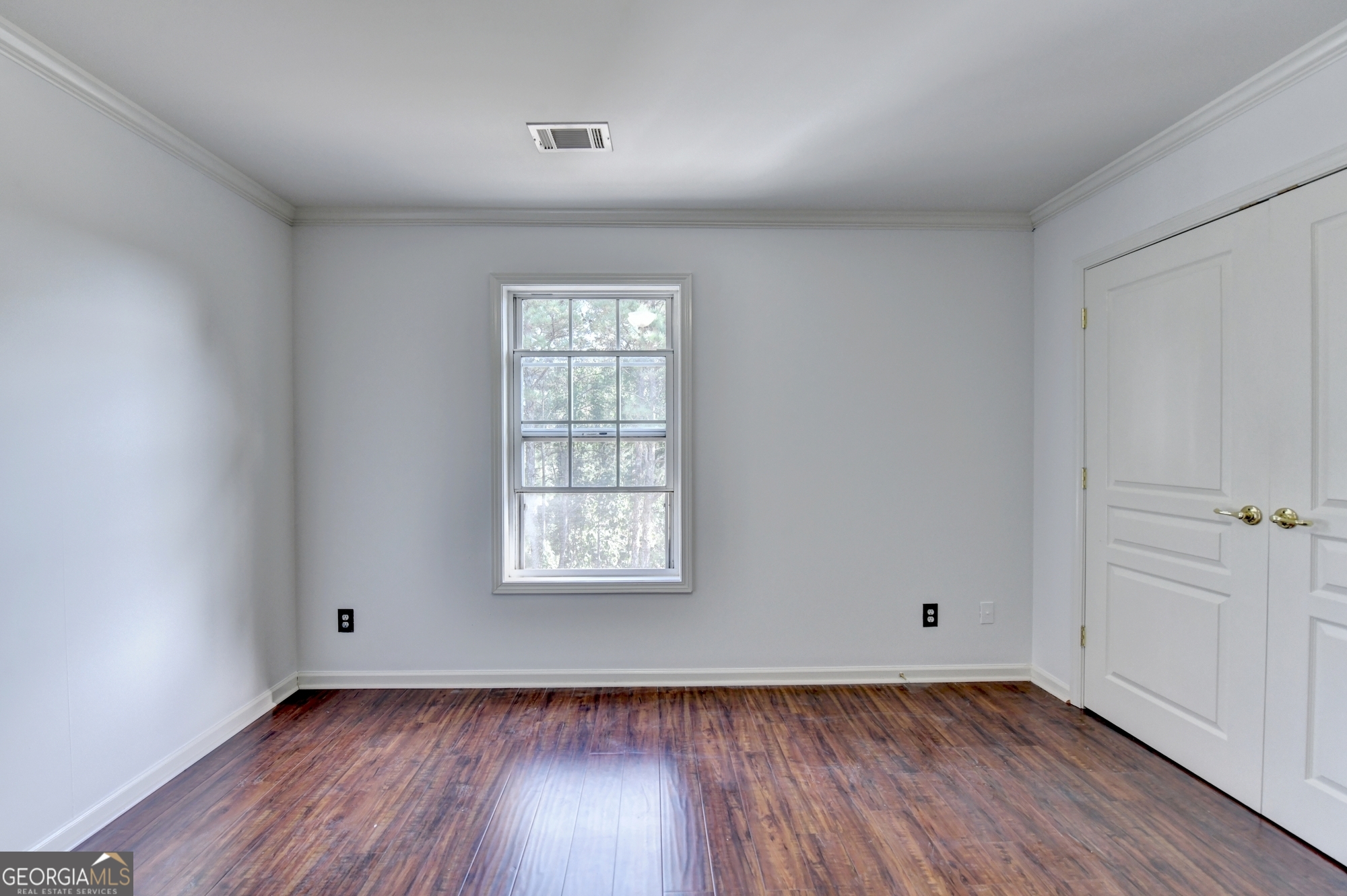 952 Cambron Cmns Trace Suwanee, GA 30024 - Photo 46 of 69 an empty room with wooden floor and windows