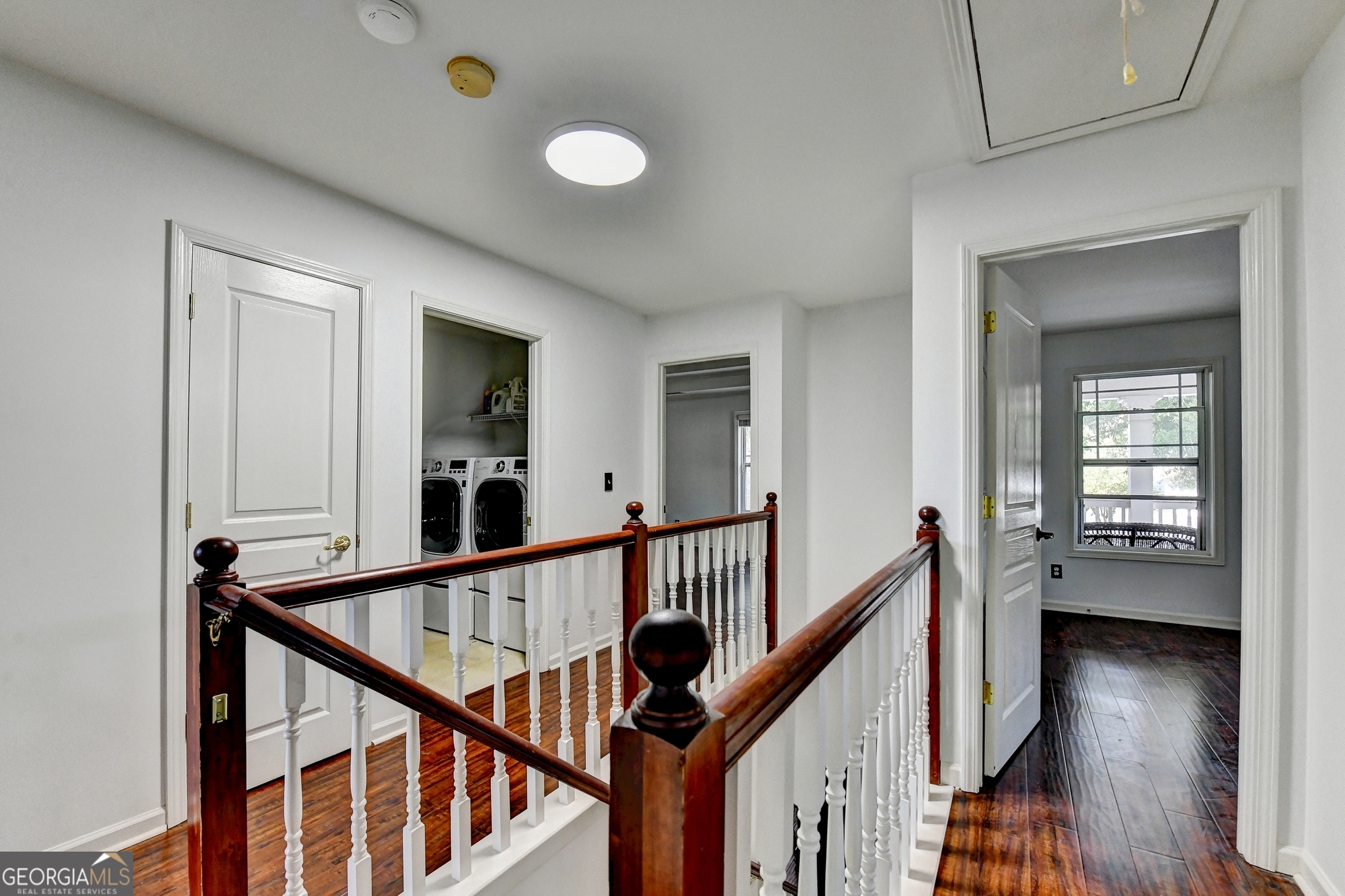 952 Cambron Cmns Trace Suwanee, GA 30024 - Photo 48 of 69 a view of a hallway with wooden floor and staircase