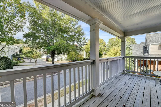 an aerial view of a chairs and table on the balcony