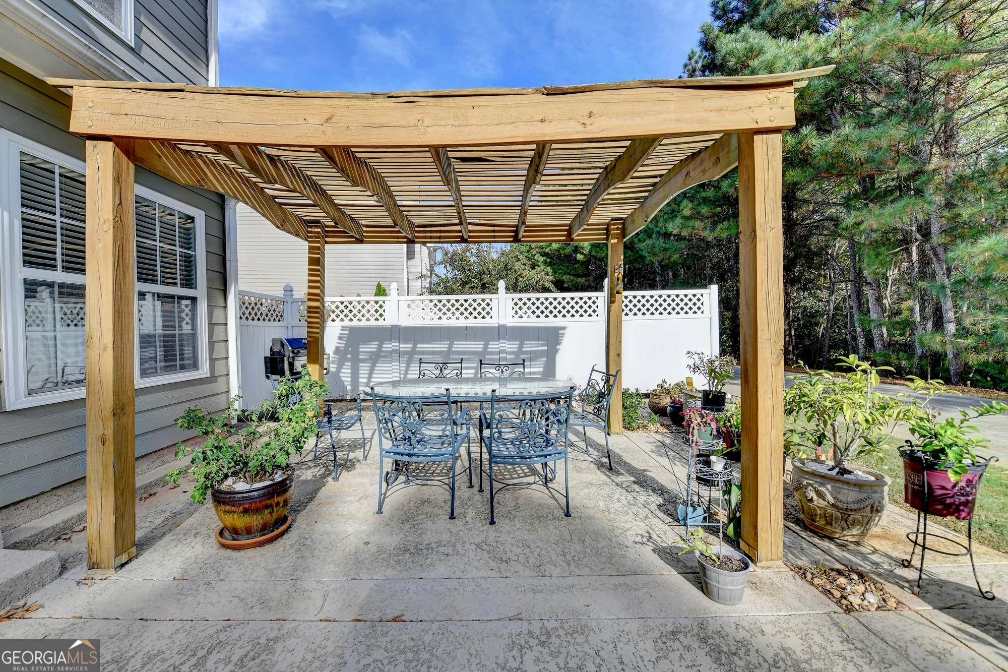 952 Cambron Cmns Trace Suwanee, GA 30024 - Photo 51 of 69 a view of patio with table and chairs potted plants