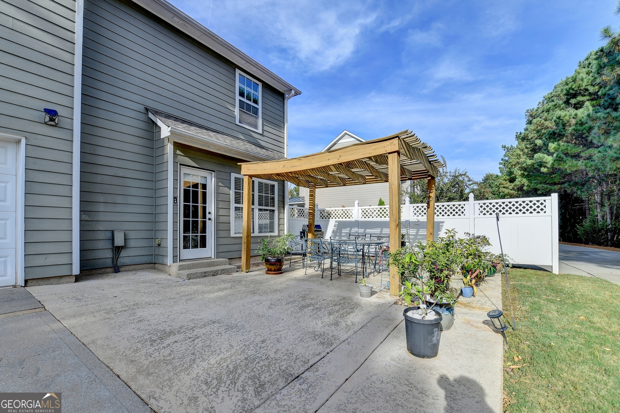 952 Cambron Cmns Trace Suwanee, GA 30024 - Photo 52 of 69 a view of a patio with table and chairs and potted plants