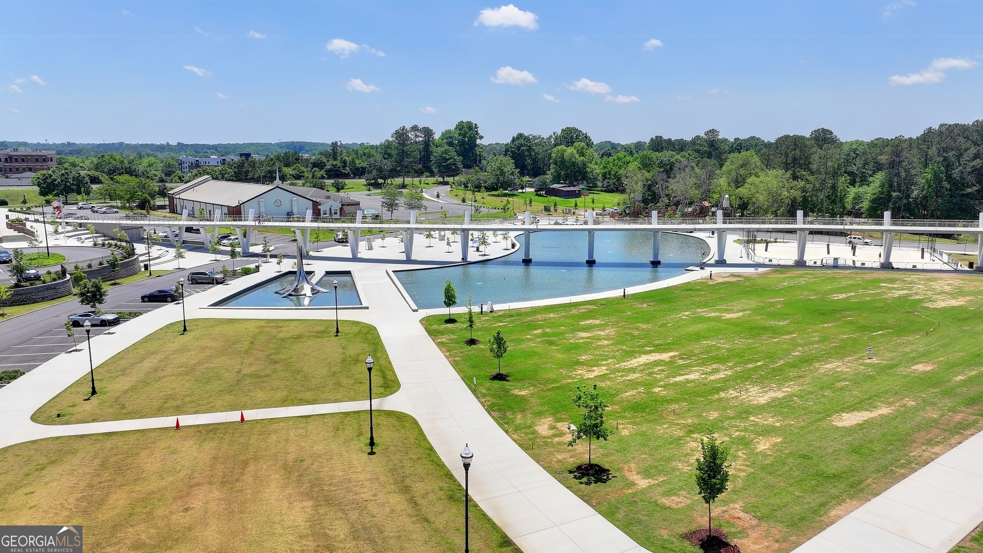 952 Cambron Cmns Trace Suwanee, GA 30024 - Photo 66 of 69 a view of a swimming pool with a garden and seating