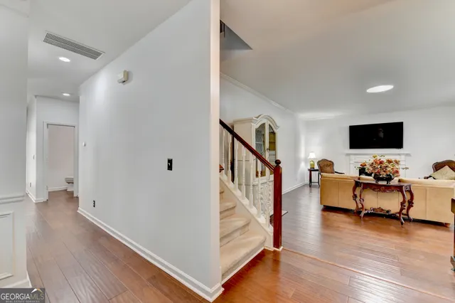 a kitchen with stainless steel appliances granite countertop wooden floors a stove and a granite counter tops
