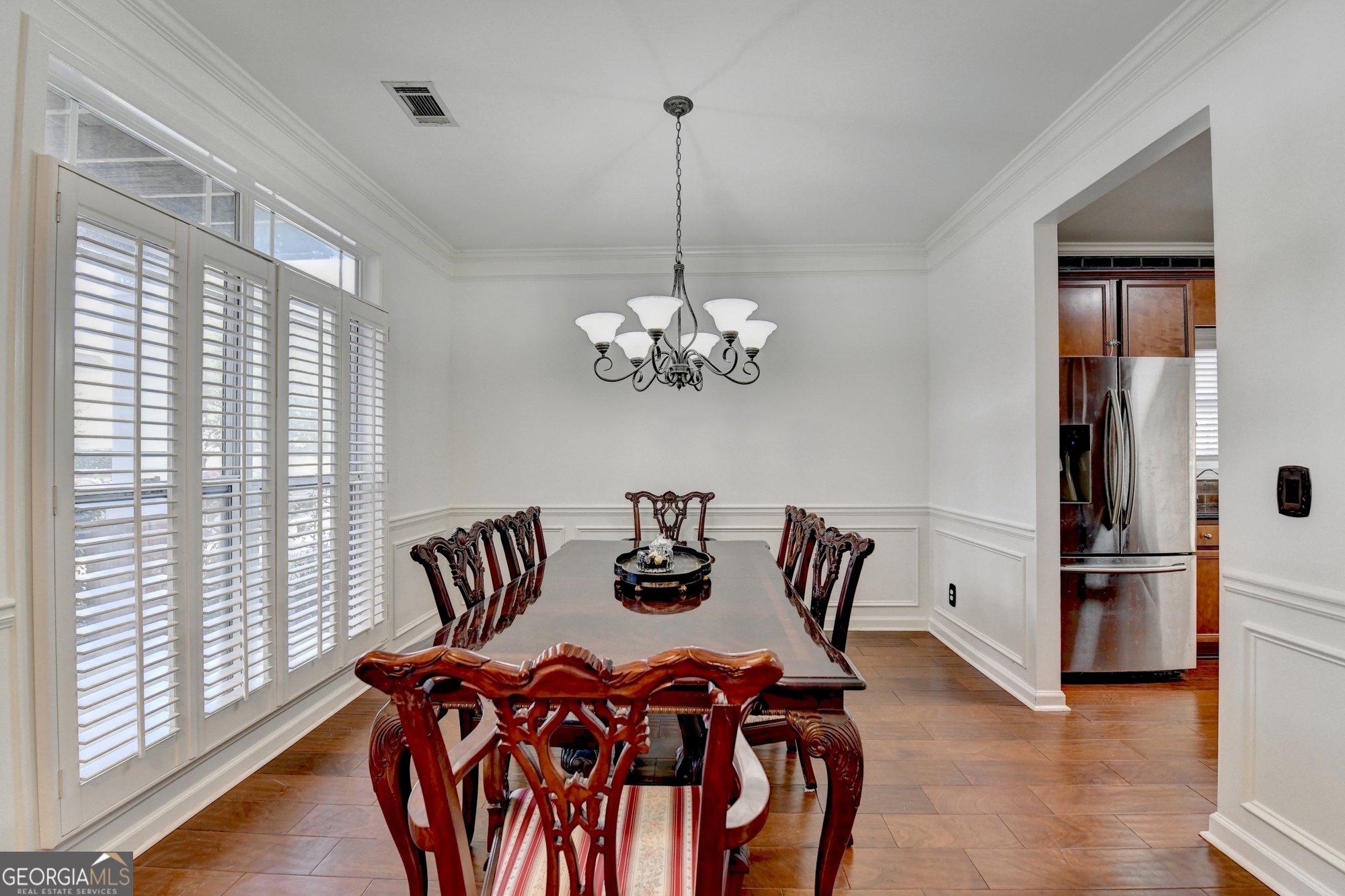 952 Cambron Cmns Trace Suwanee, GA 30024 - Photo 10 of 69 a view of a dining room with furniture wooden floor and a chandelier