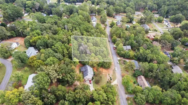 an aerial view of a houses with a yard