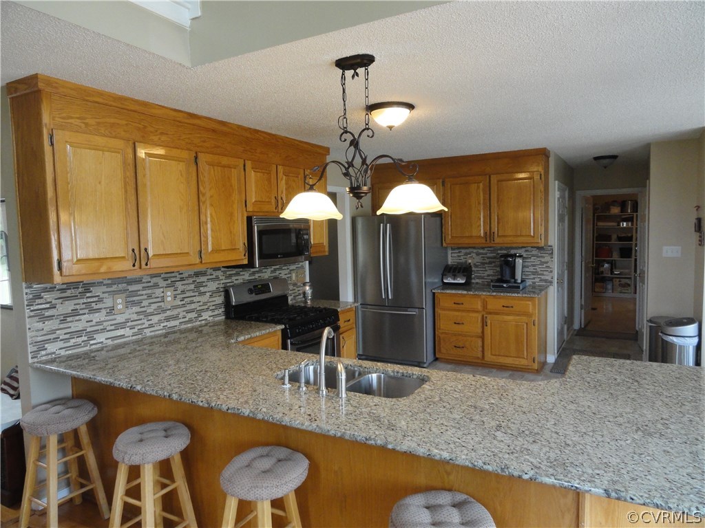 18670 Templeton Road Disputanta, VA 23842 - Photo 13 of 41 a kitchen with stainless steel appliances granite countertop a sink and a granite counter tops