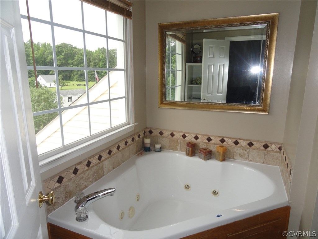 18670 Templeton Road Disputanta, VA 23842 - Photo 19 of 41 a bathroom with a bathtub and windows