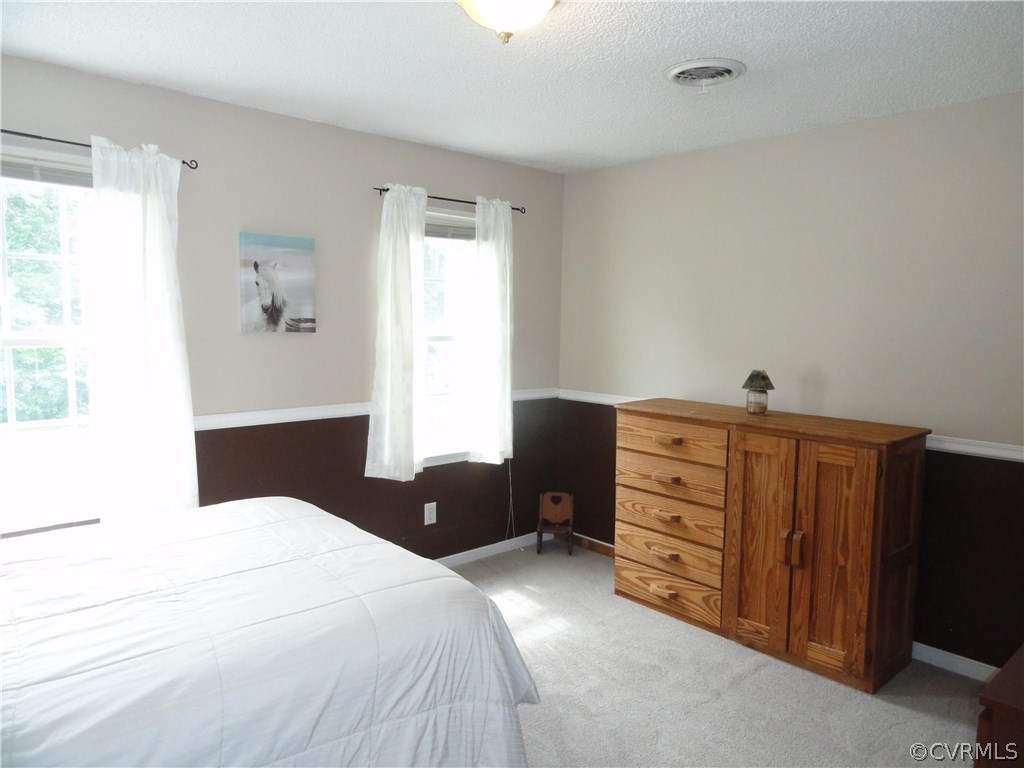 18670 Templeton Road Disputanta, VA 23842 - Photo 22 of 41 a bedroom with a bed and a dresser