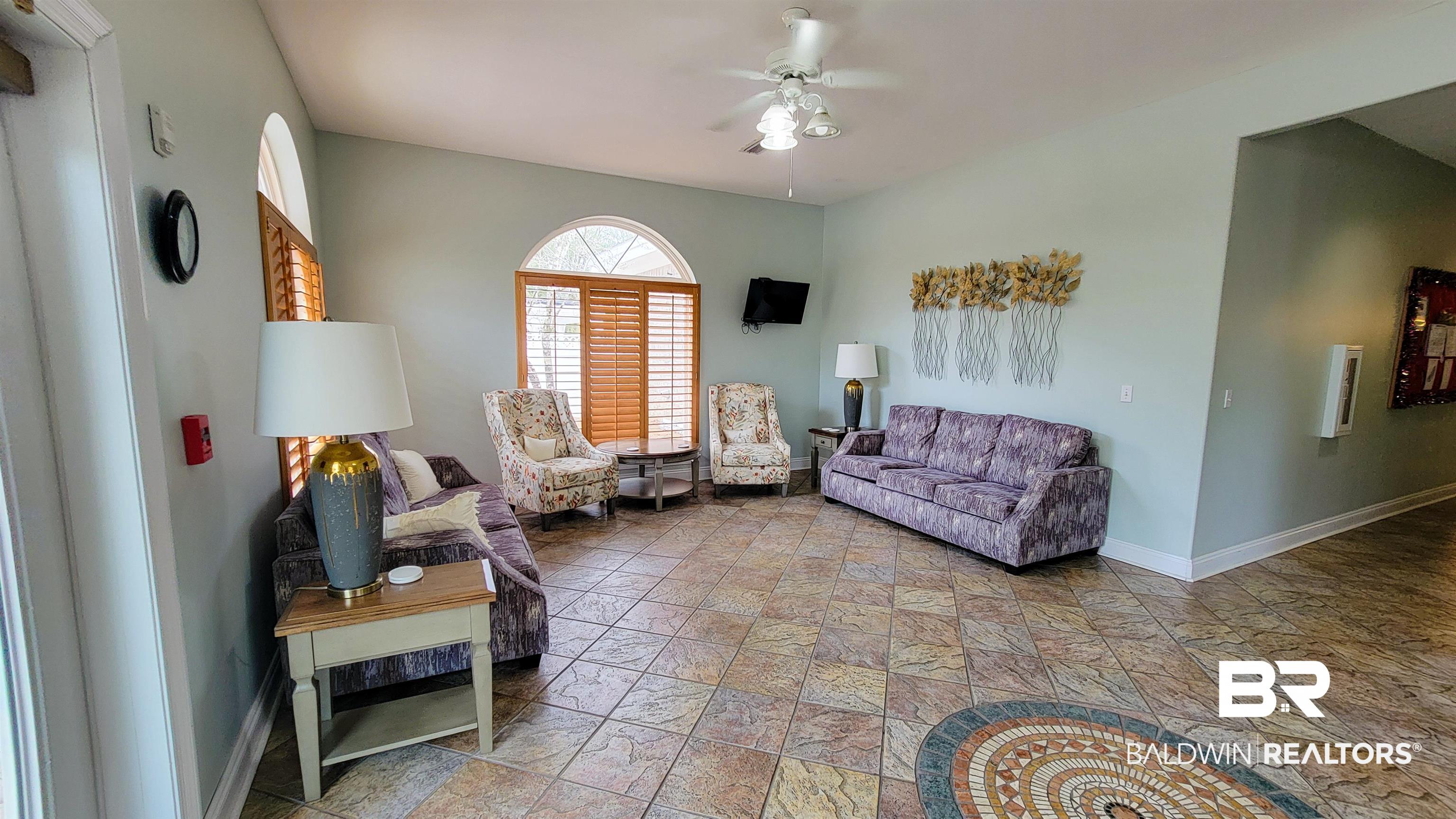 214 Hemingway Loop Foley, AL 36535 - Photo 61 of 67 Living area featuring a ceiling fan and light stone finish flooring