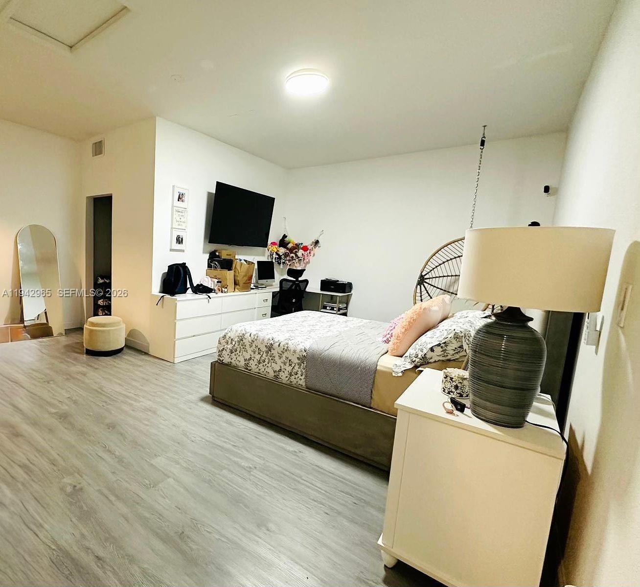 23357 Southwest 133rd Avenue Homestead, FL 33032 - Photo 11 of 14 a bedroom with bed and flat screen tv