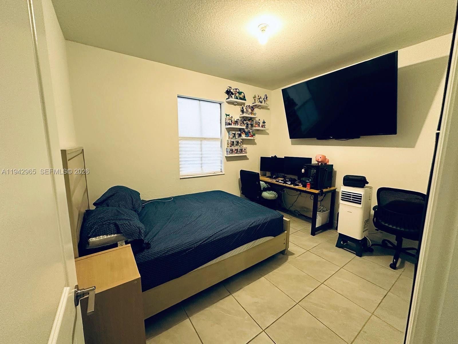 23357 Southwest 133rd Avenue Homestead, FL 33032 - Photo 13 of 14 a living room with furniture and a flat screen tv