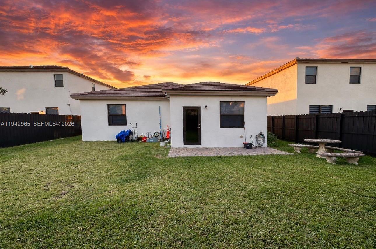 23357 Southwest 133rd Avenue Homestead, FL 33032 - Photo 14 of 14 a backyard of a house with table and chairs