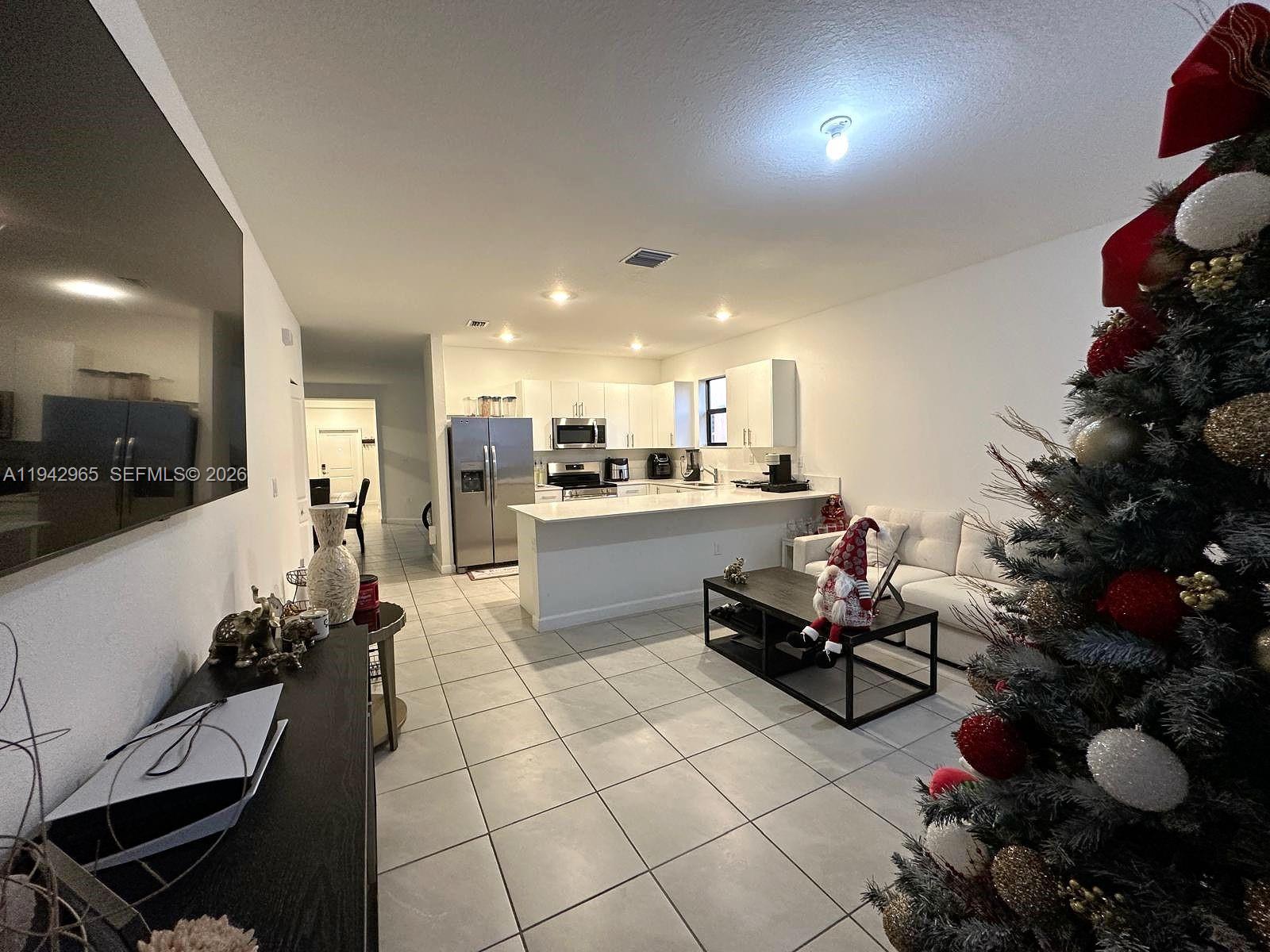 23357 Southwest 133rd Avenue Homestead, FL 33032 - Photo 7 of 14 a kitchen with granite countertop a stove and white cabinets