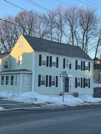 a house that has a tree in front of it