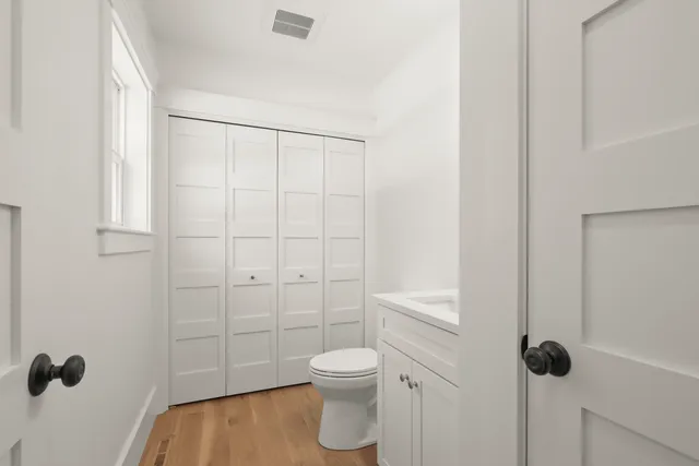 a view of a big room with wooden floor and windows