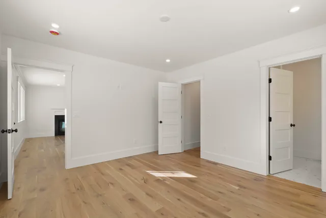 an empty room with windows and closet