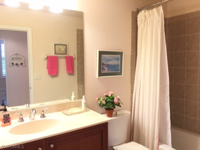 17210 Acapulco Road, Unit 211 Punta Gorda, FL 33955 - Photo 14 of 23 a bathroom with a sink vanity mirror and toilet